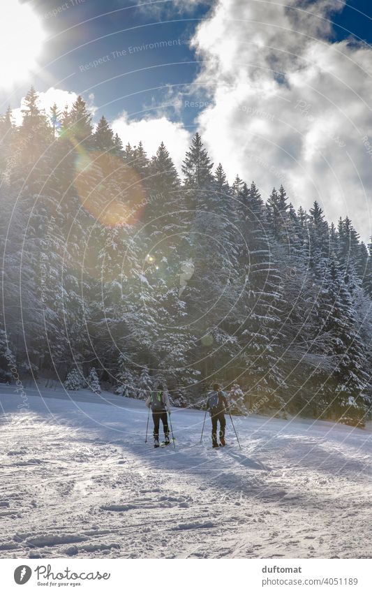 Tourers in winter landscape with mountains Sports go on tour skis Mountain Mountaineer Snow snowy Winter Athletic out two lens flair Sunlight Lens flare Bright