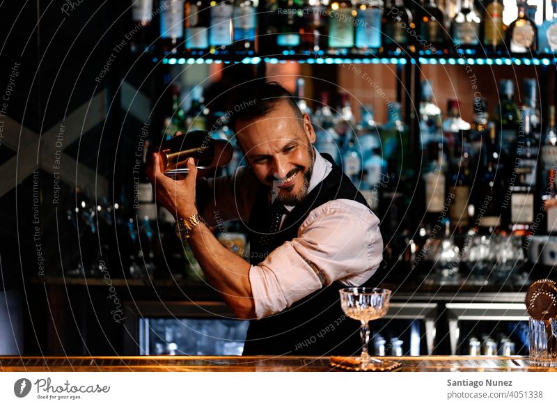 Barman is making cocktail at night club. bartender nightclub pub beverage liquor barman alcohol drink party restaurant professional nightlife preparation shaker