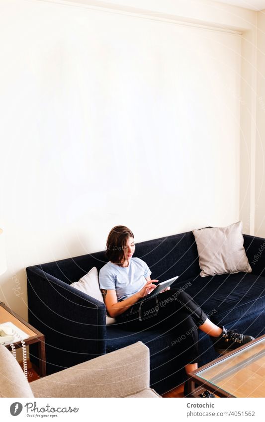 Young woman working on sofa person computer indoor laptop sitting technology home young internet communication caucasian business happy couch room smiling