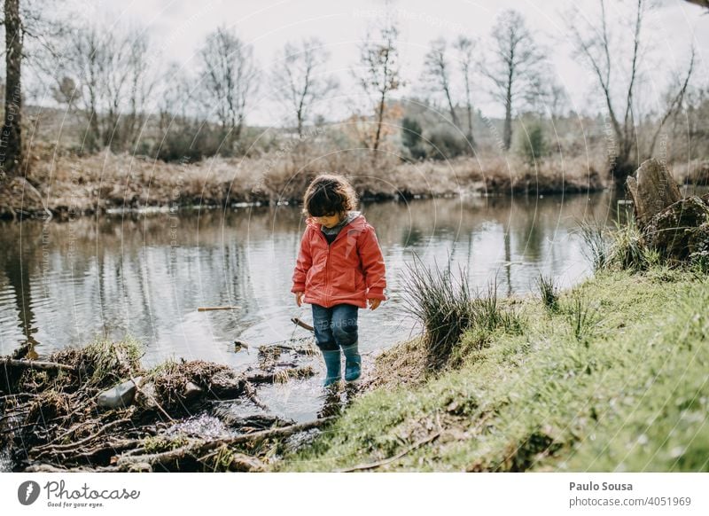 Child walking on the riverside childhood River explore Joy Happy Happiness Day Playing Colour photo Infancy Lifestyle Exterior shot Nature travel Human being