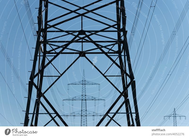 overhead line high voltage power pole lattice tower in front of blue sky Electricity pylon stream High voltage power line high-voltage cables