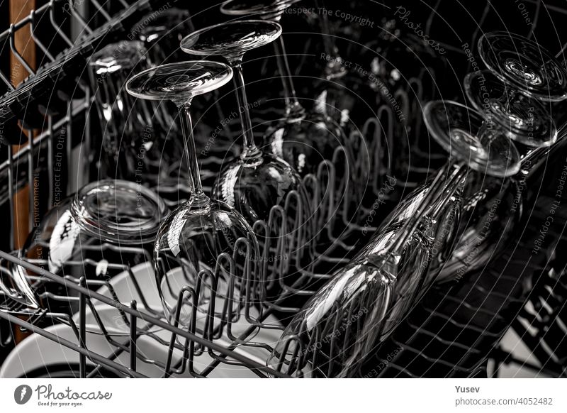 Clean shiny goblets and glasses in a dishwasher. Tableware, kitchen, housework. Close-up. clean tableware close-up household machine equipment dishware