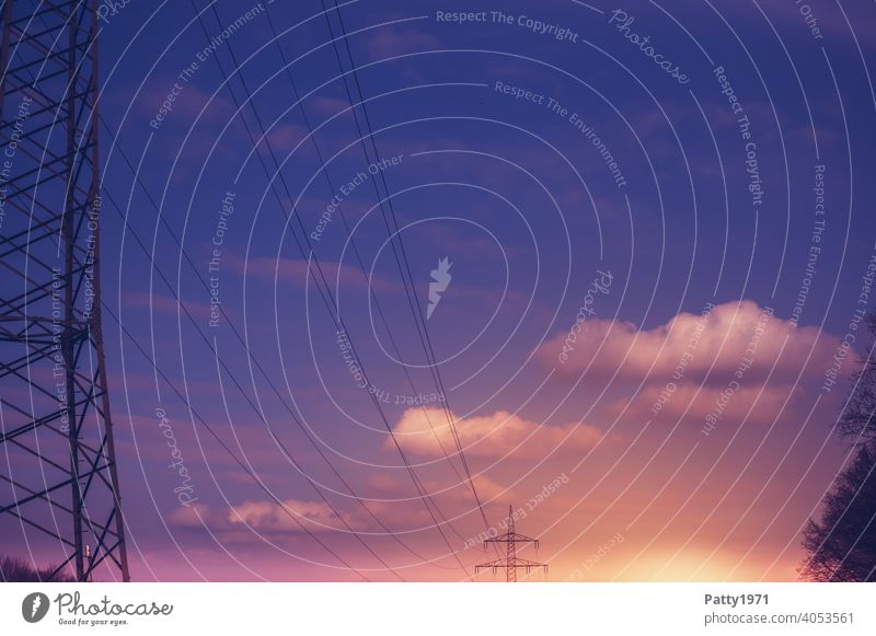 High voltage pylons in the sunset Electricity pylon power line Transmission lines High voltage power line Exterior shot Energy Technology Cable Sky