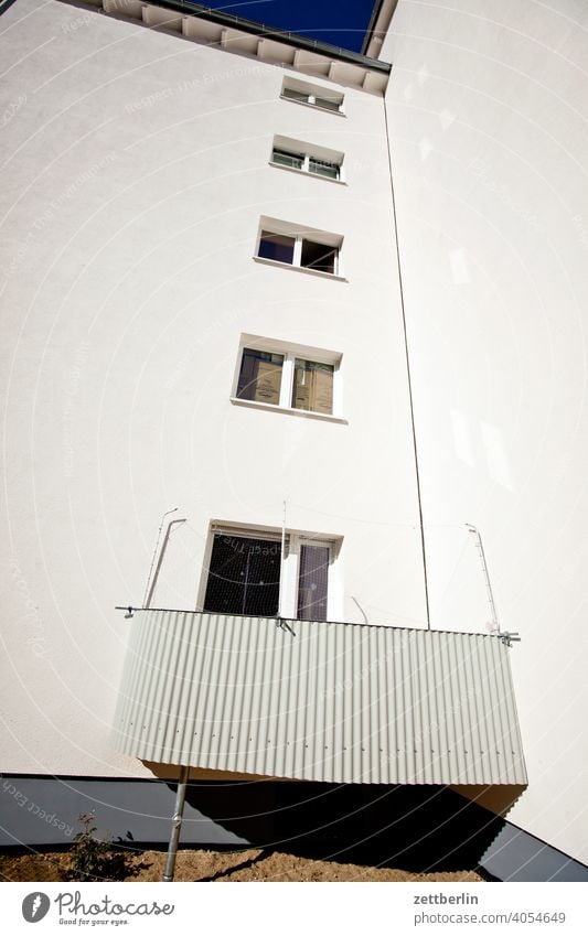 Inner city living with one balcony per house Old building on the outside Fire wall Facade Window House (Residential Structure) Sky Sky blue rear building