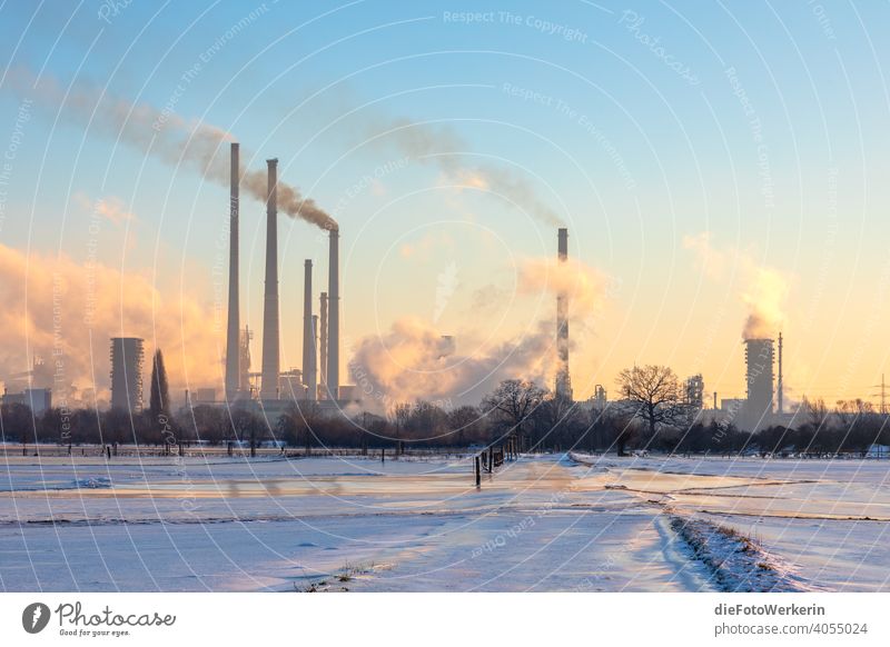 Sunrise behind industrial scenery with snow River Body of water Bright Industry Landscape Nature Snow technology Winter Chimney smoke