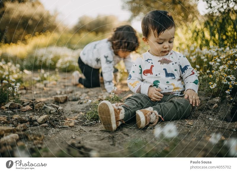 Brother and sister playing outdoors Spring Spring fever Spring flower Meadow Flower meadow Brothers and sisters Family & Relations Authentic Child childhood