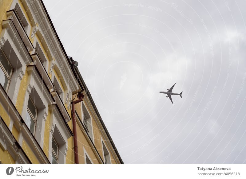 View to flying plane from below airplane city aircraft travel building transportation flight urban street high cloud town view over departure district outdoors