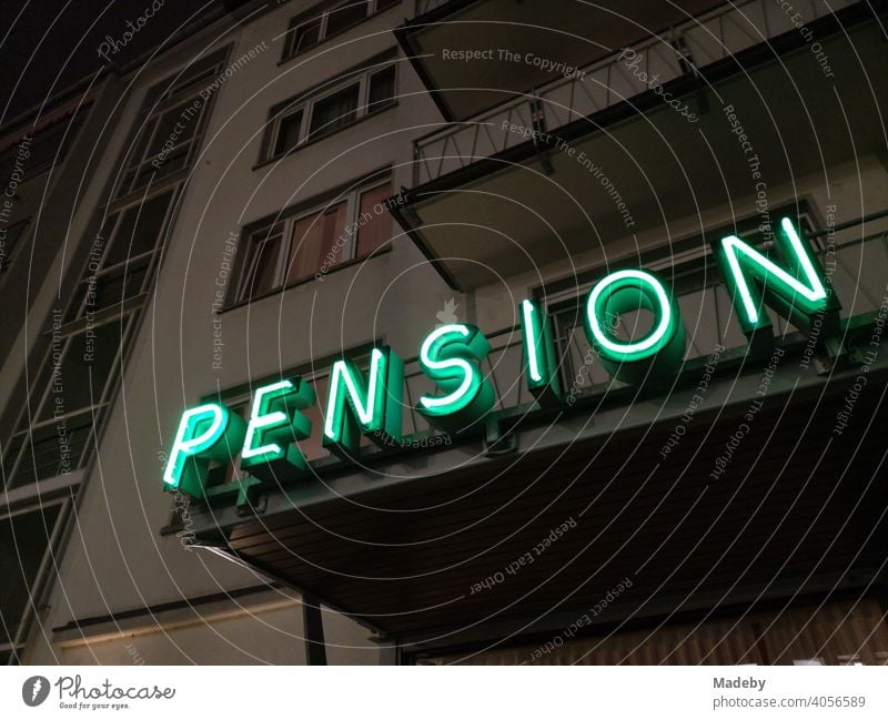 Green neon sign at night on the balcony of a boarding house in the West End of Frankfurt am Main in the German state of Hesse Boarding house Hotel Night Stay