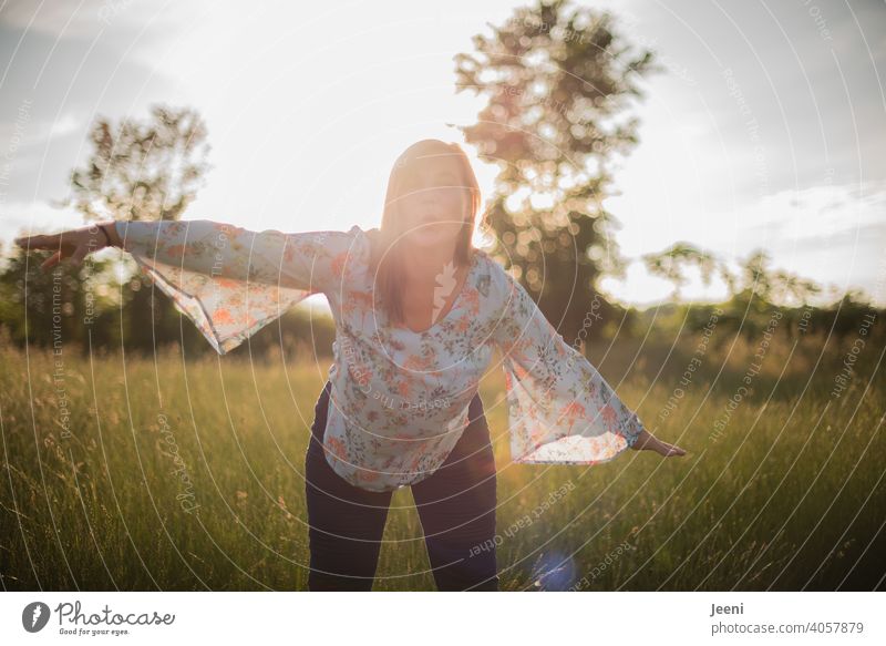 Happy woman spreads her arms like she is flying and gives an air kiss Happiness cheerful 30 - 45 years Pout Arm Flying youthful Woman feminine Smiling Feminine