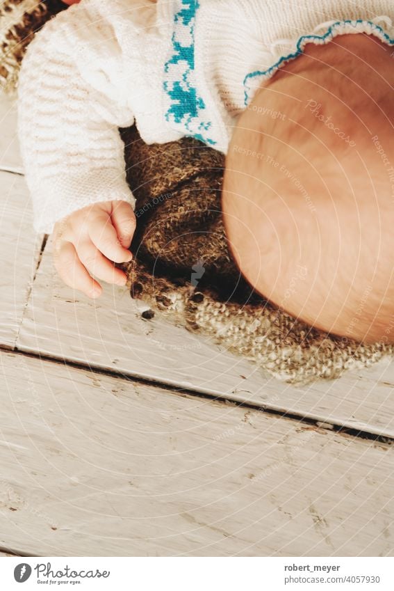 baby sleeping on a blanket Relaxation Cuteness Floor covering wood newborn boy little infant child cute childhood kid adorable beautiful human young small lying