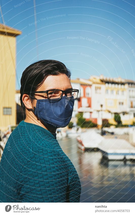 Young man wearing a face mask enjoying a sunny day in Alboraya, Valencia, Spain male holidays summer covid coronavirus flu influenza spain coast water