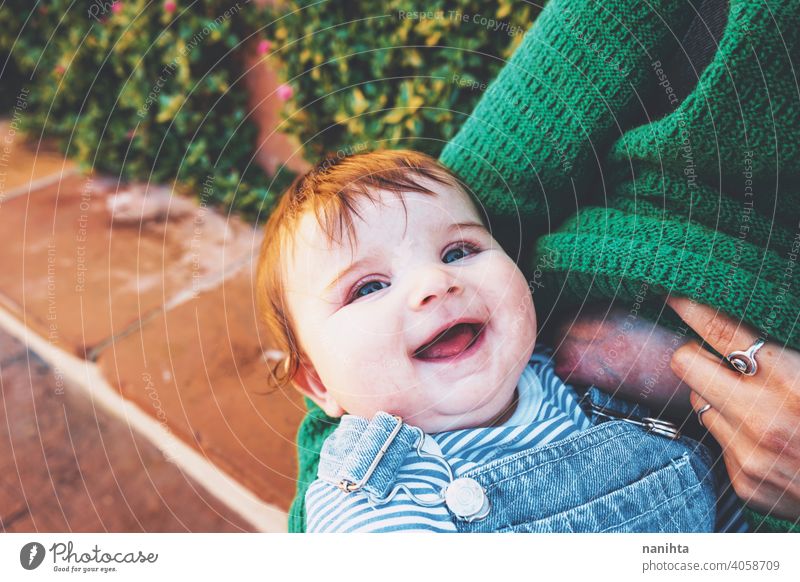 Young woman breastfeeding her baby outdoors in a sunny day young mother mom family green holidays leisure health blonde care childhood parenthood babyhood