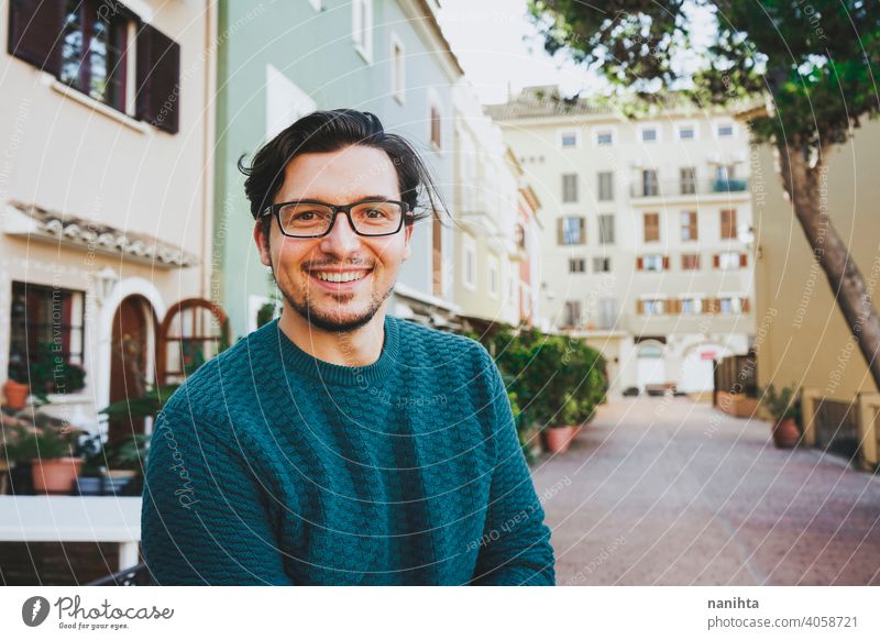 Smiling young man against a urban scene portrait male happy happiness smile smiling face mood city hairstyle lifestyle street joy enjoy warm warmth casual wear