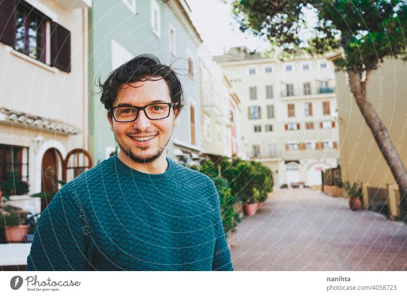 Smiling young man against a urban scene portrait male happy happiness smile smiling face mood city hairstyle lifestyle street joy enjoy warm warmth casual wear