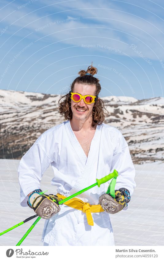 Skier dressed as a karateka at a ski station Sports action active activity adventure artistic beautiful cold cool costume downhill extreme extreme skier fast