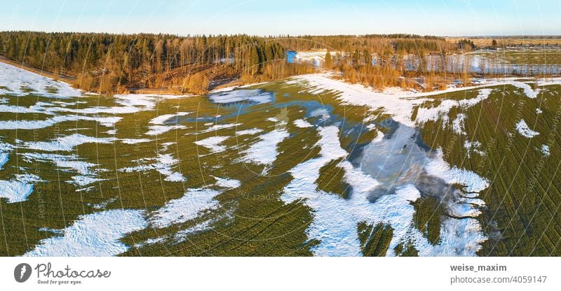 Season change. March rural landscape. Winter crops and plowed field panorama. snow spring nature aerial season background tree white forest green winter road