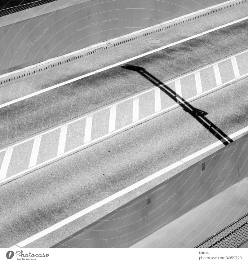 Opposite Transport Street Car-free Shadow sunny Tracks lines Median strip Road sign Gray Asphalt Pavement Bird's-eye view Diagonal rail Surface opposite