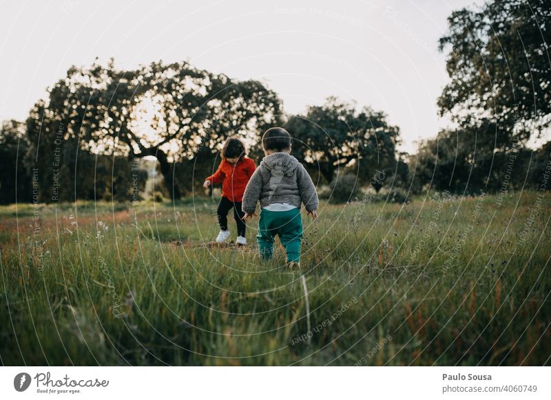 Brother and sister playing outdoors Brothers and sisters Family & Relations Child childhood Lifestyle Exterior shot Toddler Joy Happiness Colour photo Infancy