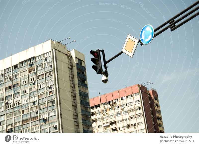 Traffic light and road signs with multistory buildings on the background. apartment architecture blue blue sky camera cathedral of learning centre city