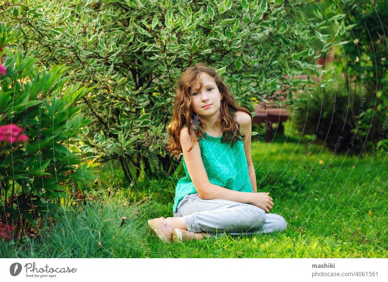 kid girl walking and relaxing in summer beautiful garden child flower nature childhood outdoor happy happiness green cute fun little playing smiling young