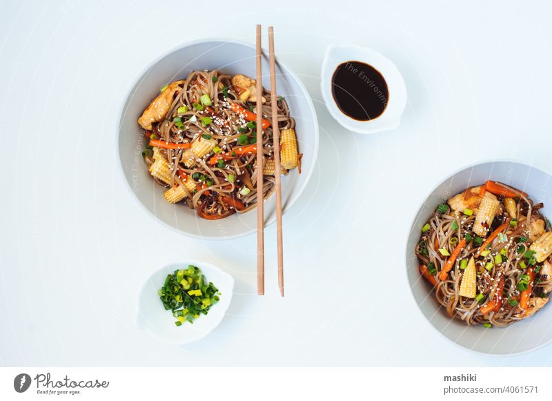 Japanese dish buckwheat soba noodles with chicken and vegetables carrot, onion and baby corn food chopstick bowl meal healthy lunch asian dinner japanese