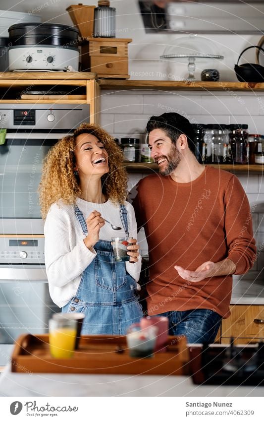 Couple talking in kitchen. middle age couple love cooking home cozy caucasian relationship preparing female happy person stove woman beautiful girl smiling two