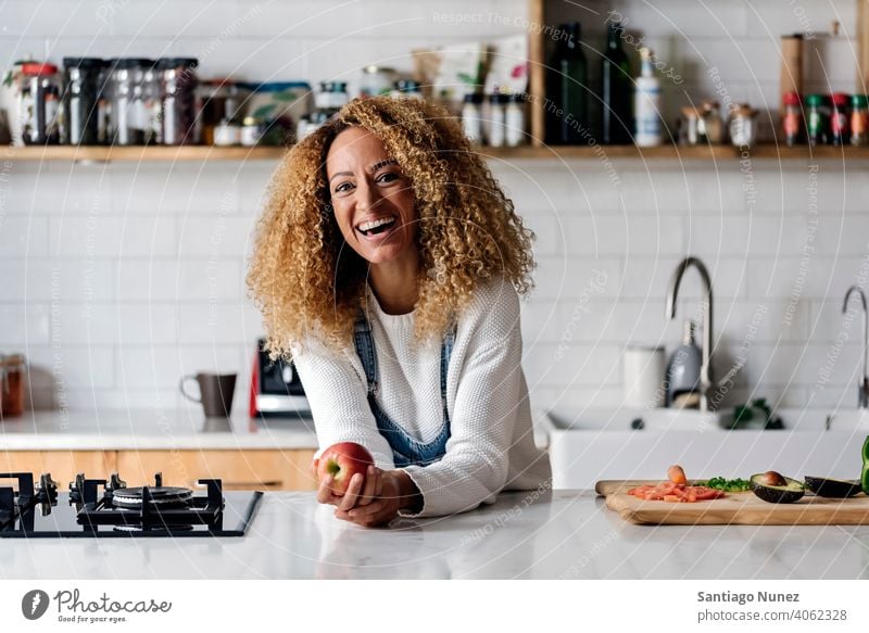 Portrait of a woman in the kitchen. middle age home cozy relationship preparing female happy person stove alone beautiful girl smiling table interior attractive