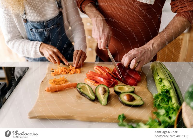 Couple preparing food in kitchen. middle age couple love cooking home cozy caucasian relationship female happy person stove woman beautiful girl smiling two