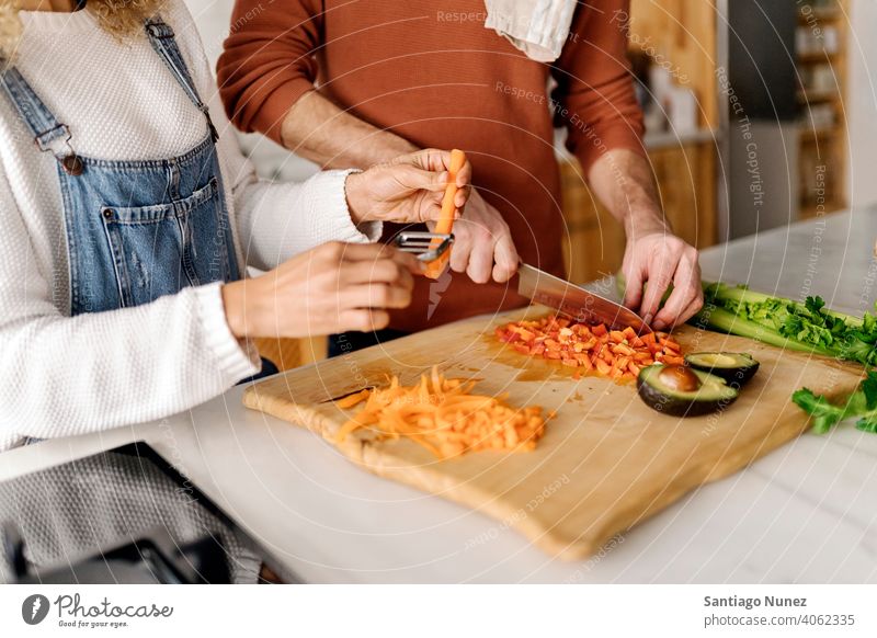 Couple preparing food in kitchen. middle age couple love cooking home cozy caucasian relationship female happy person stove woman beautiful girl smiling two