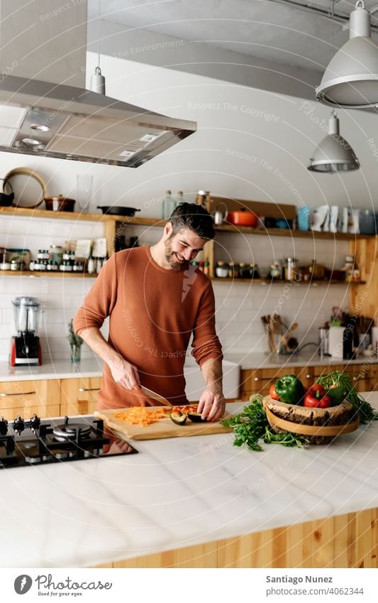 Man preparing food in kitchen. middle age couple love cooking home cozy caucasian relationship happy person stove alone girl smiling table interior attractive