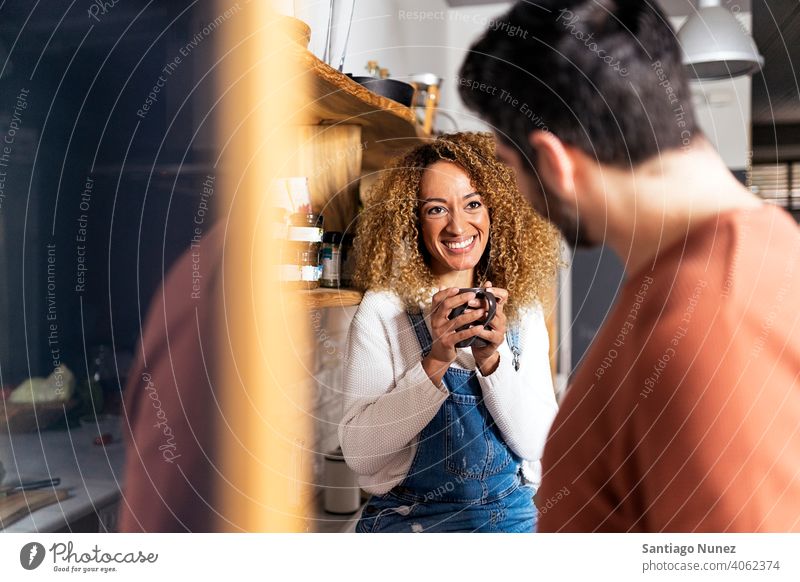 Couple laughing and standing in kitchen. middle age couple love cooking home cozy caucasian relationship preparing female happy person stove woman beautiful