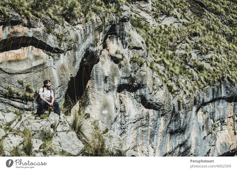 Hiker with backpack enjoying valley view from top of a mountain tourist travel man rock hiking peak tourism park tree trekking freedom endurance activity