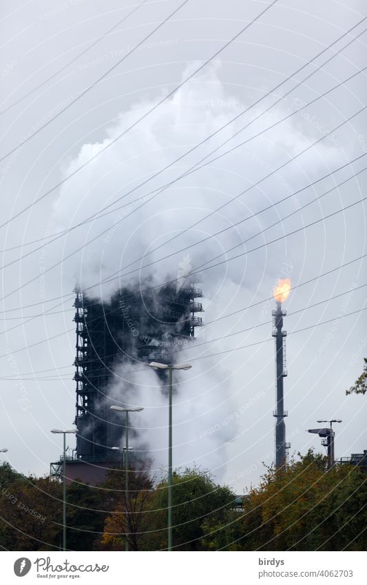 Extinguishing tower of the steelworks Thyssen-Krupp coking plant in Duisburg. enormous steam cloud, extinguishing cloud which arises during the cooling of hot coke in a wooden tower, the extinguishing tower.