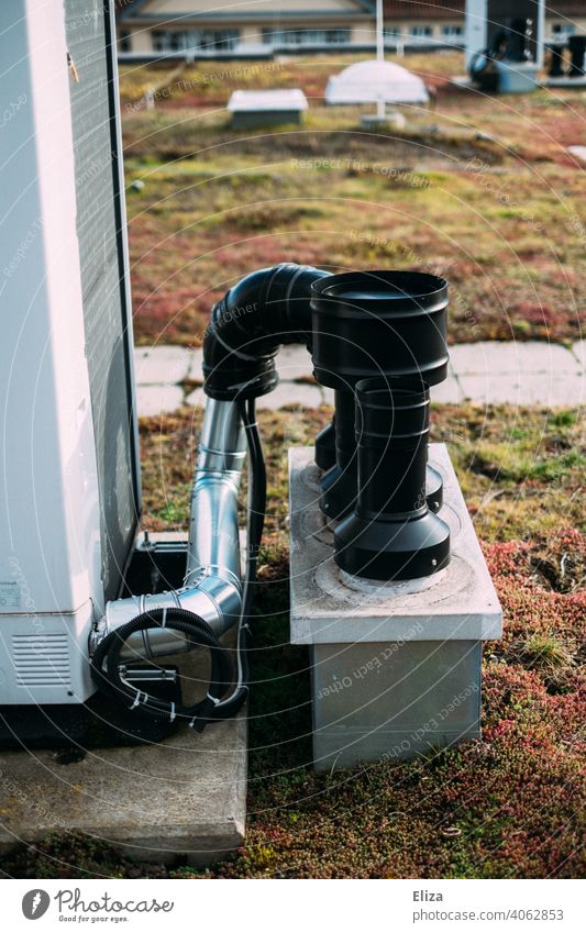 Air source heat pump system on the roof of a residential building. Modern and environmentally friendly heating technology. Heating Sustainability