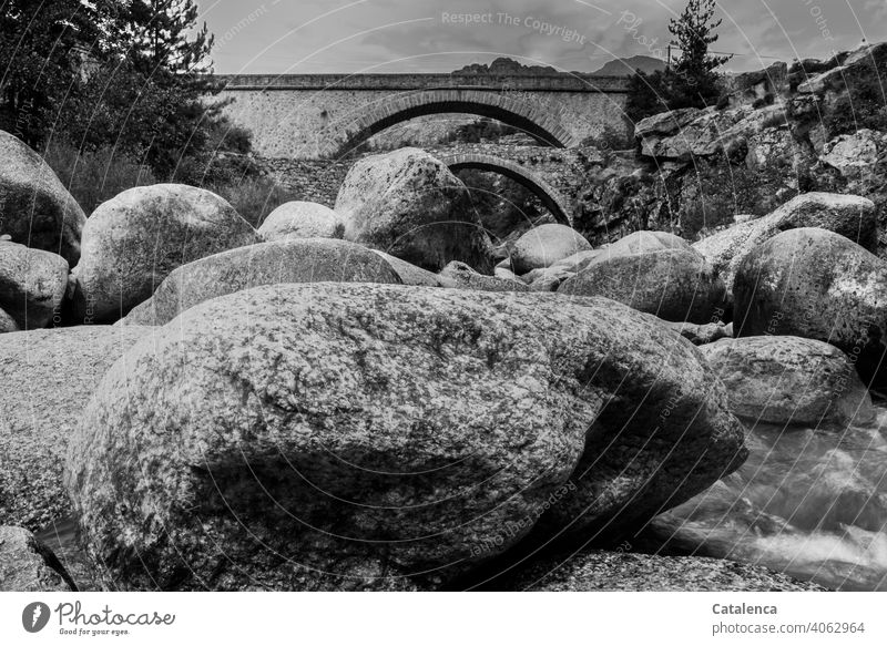 Two old stone bridges span the rocky mountain stream Nature Water Brook Flow swift Bubbling mountain brook Body of water mountains Bridges stones Stone Bridges