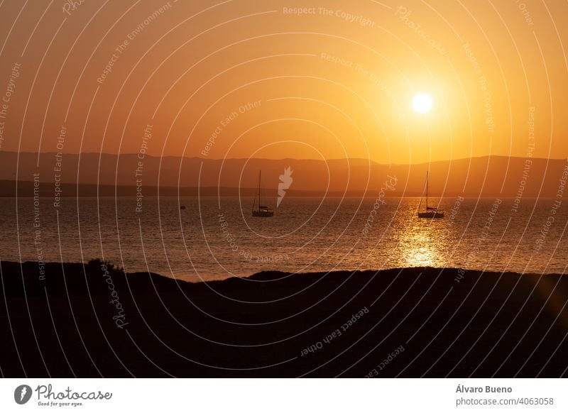 Landscape at sunset, Paracas bay, Peru. photography travel South America silhouettes mountains hills sea boats sail mast anchored water waves surface bright