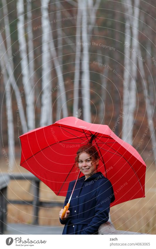 Morning tune Woman Girl Young woman Leisure and hobbies Forest Lanes & trails off Umbrella Umbrellas & Shades Red Sunshade