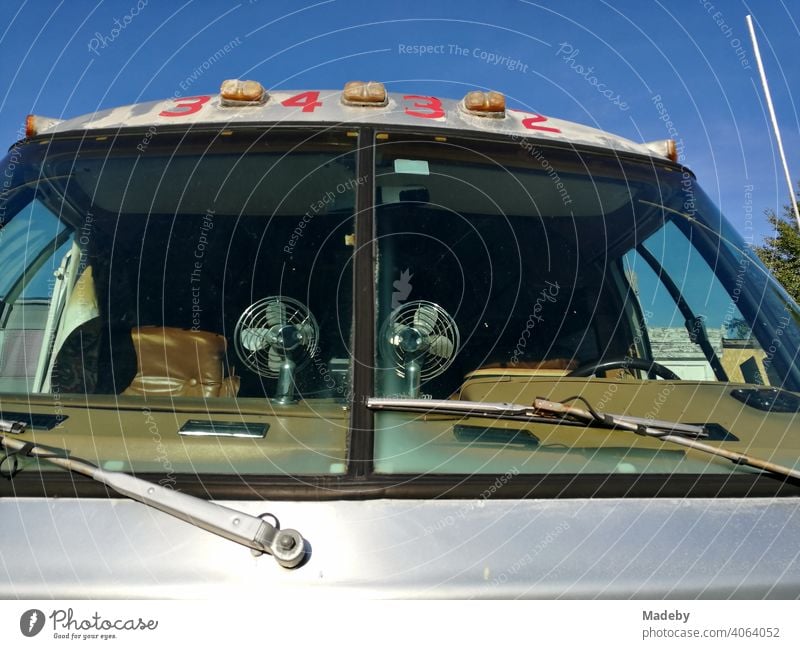 Classic American Airstream motorhome with tinted windows and fans on the dashboard in summer sunshine in Detmold in Ostwestfalen-Lippe, Germany silver Silver