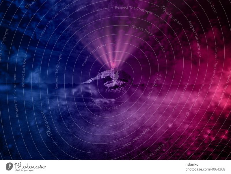 view of the valley with a high mountain at night, at the top of the mountain peak neon circle with pink glow and rays perspective season magic smoke cloudy dark