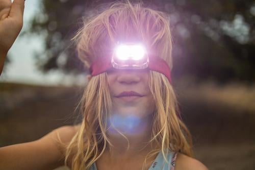 Girl with Head Torch Outdoors fun people summer camping retro vintage flashlight travel adventure outdoors childhood kid head torch headlamp evening dark adult