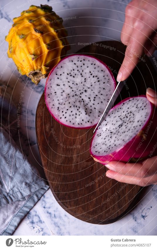 Dragon fruit cut and exposed on a light background. thai nature ripe alimentary fresh red health healthy closeup macro pink dragon vibrant food juicy asia