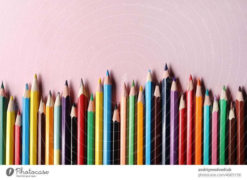 Color pencils set, row wooden color pencils isolated on pink background. colored pencils for drawing. copy space. up close sharp rainbow group green education