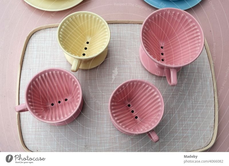 Porcelain coffee filter holder in yellow and pink on a tray in the style of the fifties on the flea market at the Golden Oldies in Wettenberg Krofdorf-Gleiberg near Giessen in Hesse