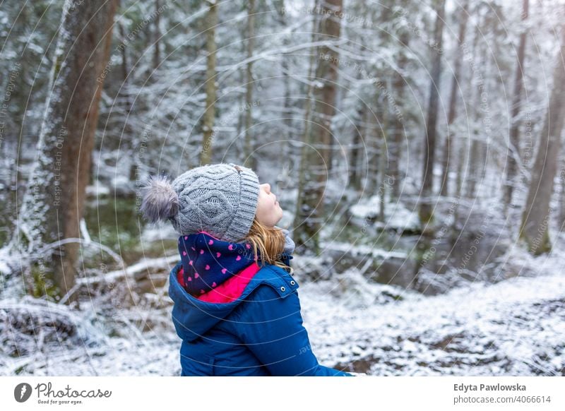 Little girl enjoying a walk through the woodland in winter trees child snow forest cold wilderness hiking active beautiful bialowieza childhood december dense