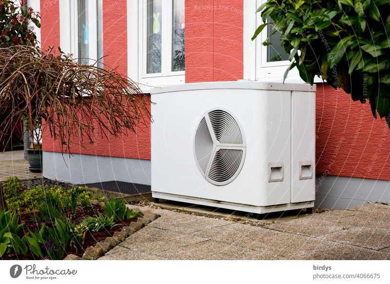 Air source heat pump in front of a terraced house. Modern, environmentally friendly heating technology, air source heat pump Heating Air-to-water heat pump