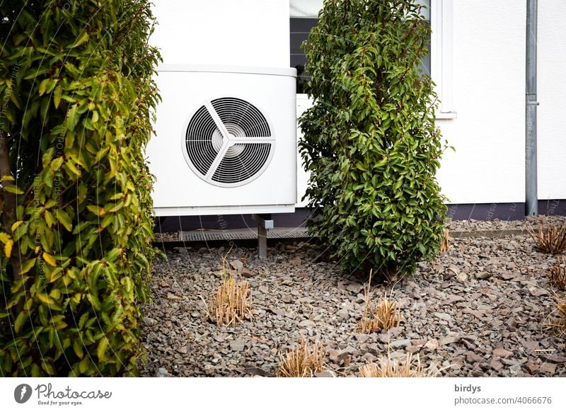 Air source heat pump in the front garden of a house. Modern, environmentally friendly heating technology. Air source heat pump Heating Air-to-water heat pump