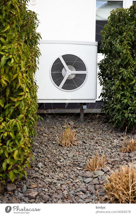 Air source heat pump in the front garden of a house. Modern, environmentally friendly heating technology. Air source heat pump Heating Air-to-water heat pump