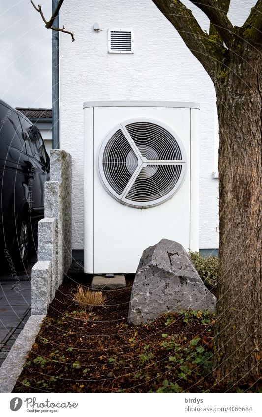 Air source heat pump in the front garden of a house. Modern, environmentally friendly heating technology. Air source heat pump Heating Air-to-water heat pump