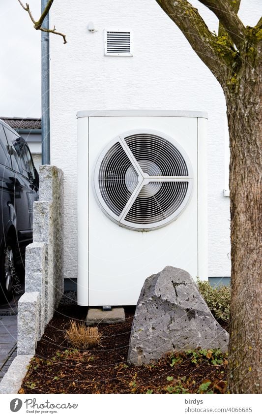 Air source heat pump in the front garden of a house. Modern, environmentally friendly heating technology. Air source heat pump Heating Air-to-water heat pump