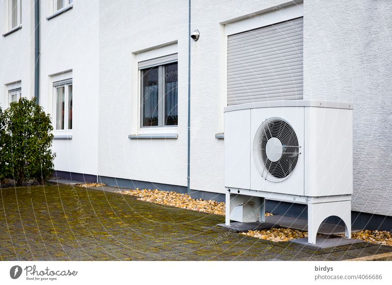 Air source heat pump in front of a terraced house. Modern, environmentally friendly heating technology, air source heat pump Heating Air-to-water heat pump